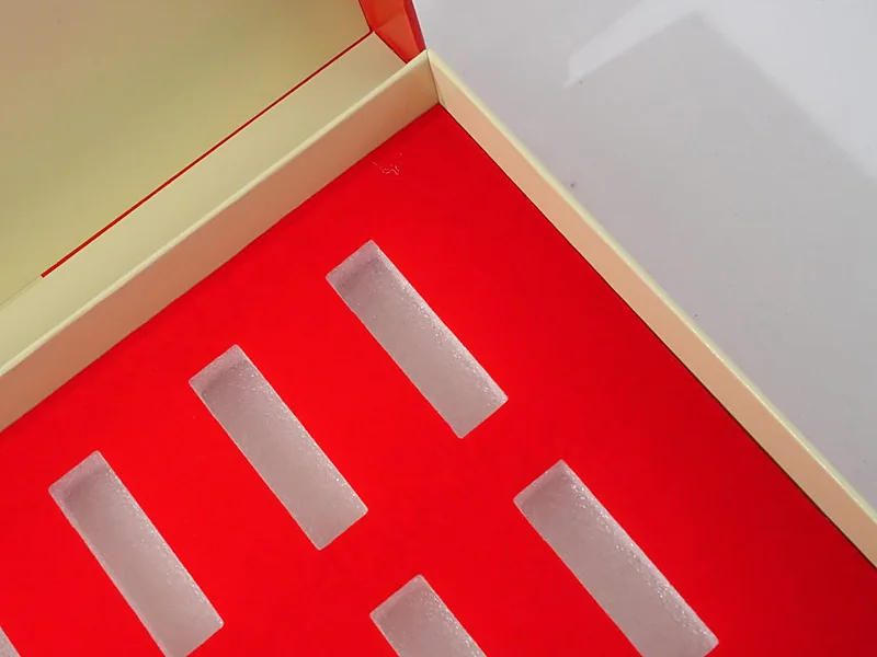 EPE foam protective bars nested in a red lined gift box