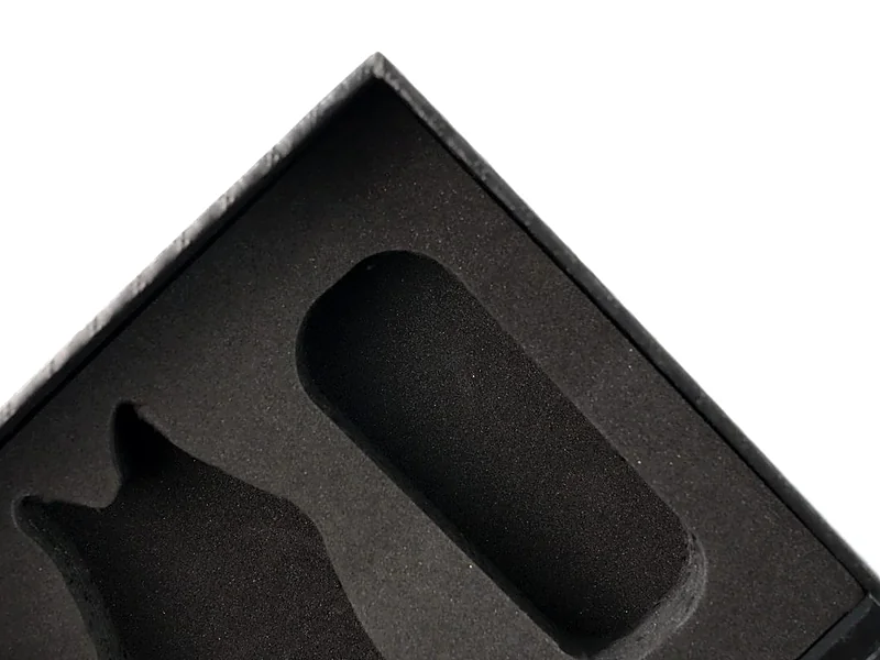 Black EVA foam insert with die-cut cavities inside a rigid box