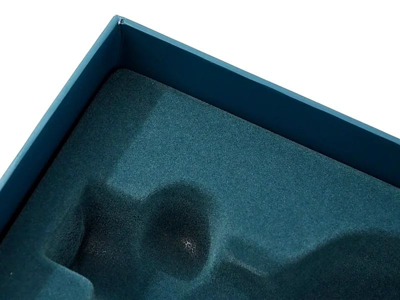 Navy flocked plastic insert lining a rigid box interior