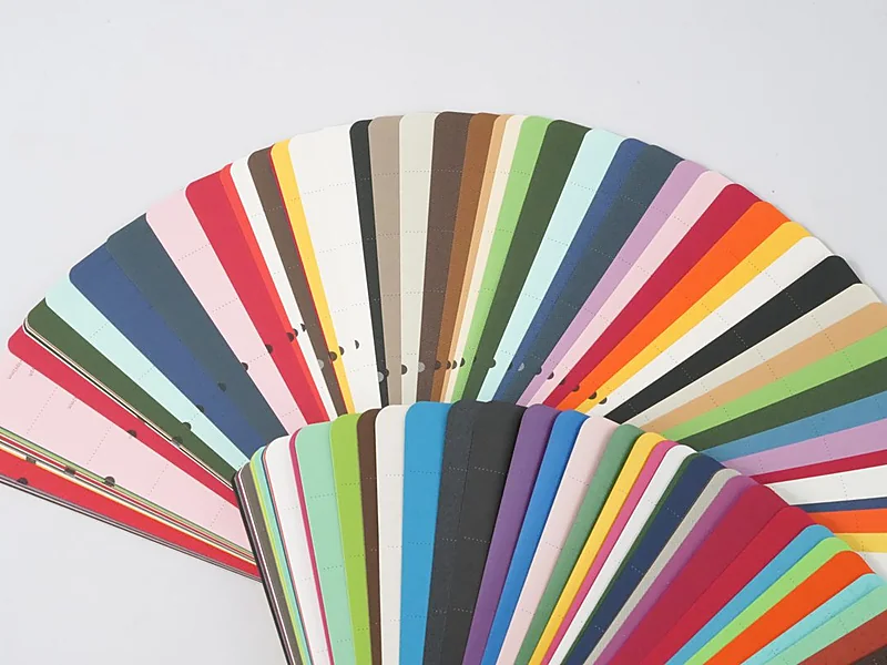 Fan of specialty textured paper swatches in assorted colors and finishes